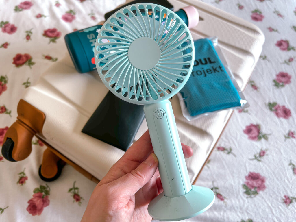 turquoise hand fan is a must have for holidays in 2023